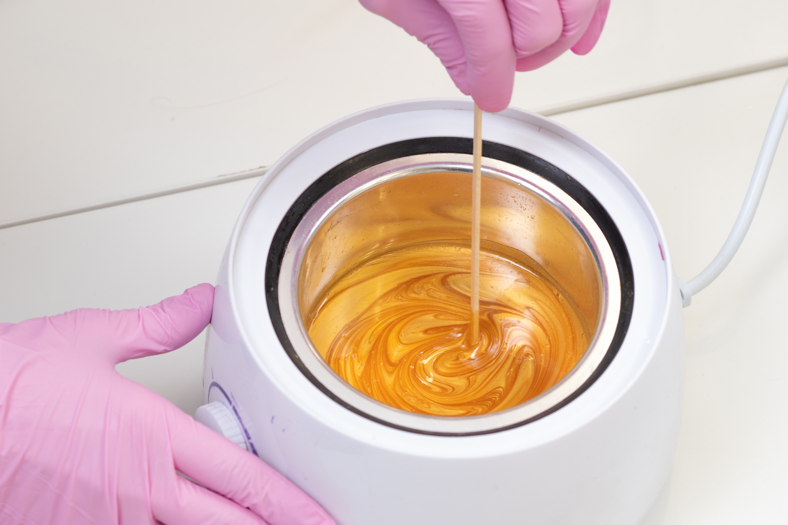 Wax for hair removal. Molten wax in a special container for heating the wax.